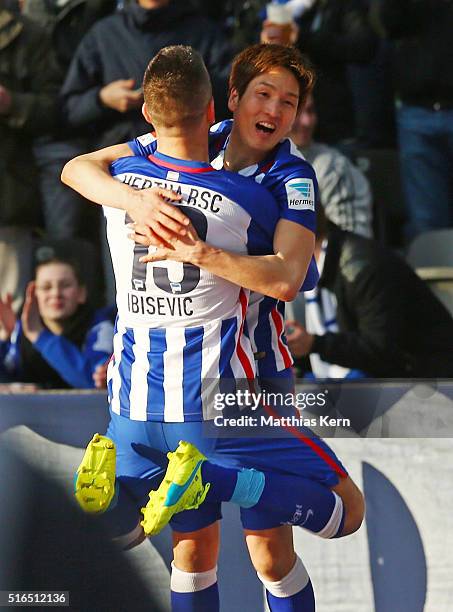 Genki Haraguchi of Berlin jubilates with team mate Vedad Ibisevic after scoring the first goal during the Bundesliga match between Hertha BSC and FC...