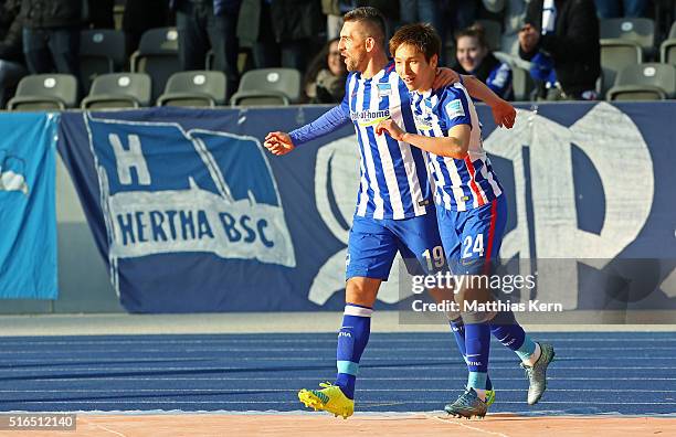 Genki Haraguchi of Berlin jubilates with team mate Vedad Ibisevic after scoring the first goal during the Bundesliga match between Hertha BSC and FC...