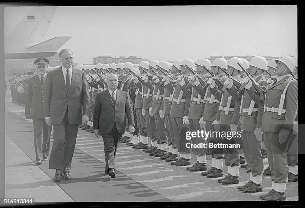 Rome, Italy: West German chancellor Helmut Kohl , accompanied by Italian prime minister Amintore Fanfani , reviews honor troops after his arrival at...