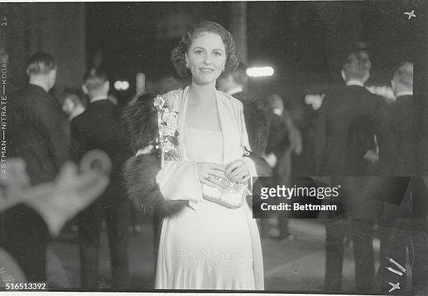 Dorothy Burgess, pretty stage and screen star, smiles on her arrival at Grauman's Chinese Theater in Los Angeles for the premiere of Cavalcade.