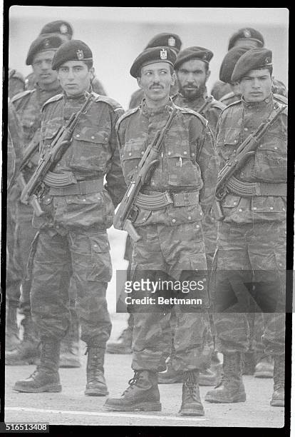 Young Palestinian guerillas with their AK-47 slung on their chests stand at attention as Yasser Arafat addresses PLO guerillas at this training camp...