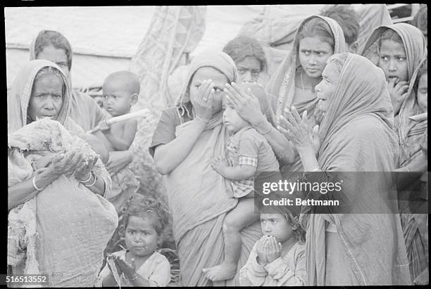 Rangaloo, Assam, India: Grieving women and their children of the village of Rangaloo, where many of the residents were massacred and their homes put...