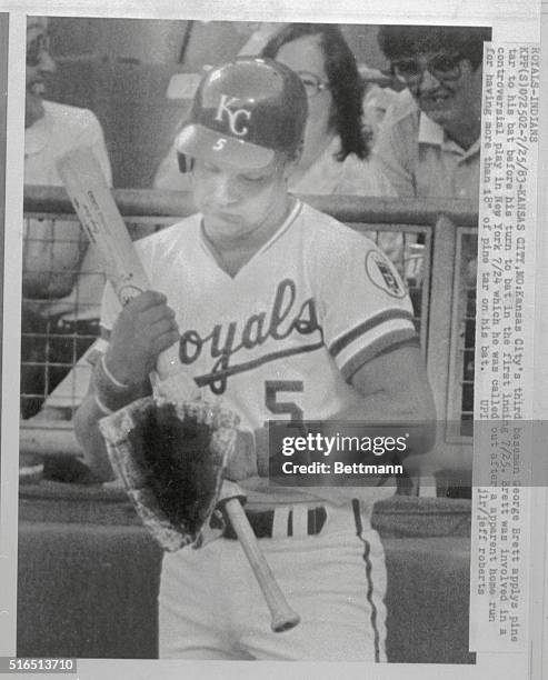 Kansas City Royal's third baseman George Brett is applying pine tar to his bat before his turn to bat in the first inning. Brett was involved in a...
