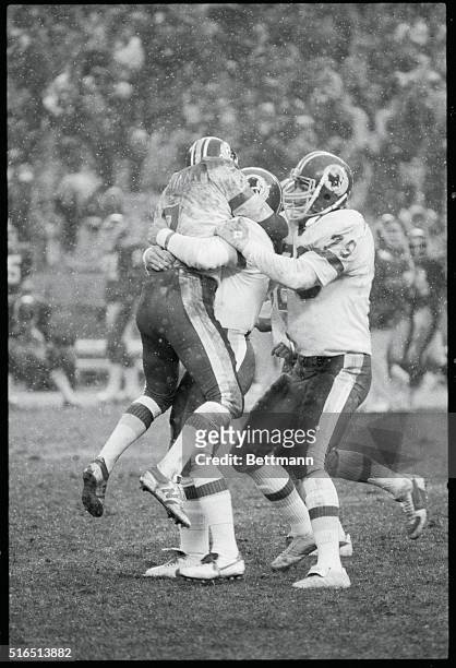 Washington: Redskin Mark Moseley is mobbed by teammates Joe Theisman and Todd Liebenstein after kicking the winning field goal with 4 seconds left in...