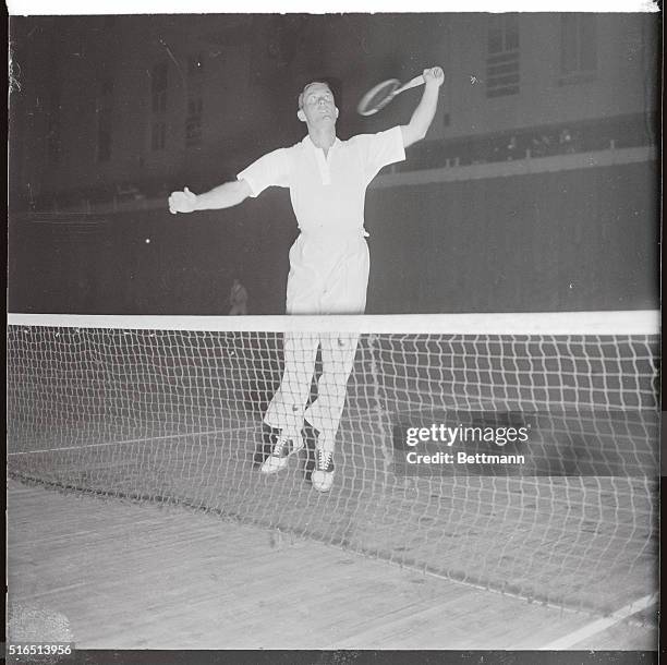 George Lott, the only seeded star to lose a set during the opening day of the men's national indoor championship at the Seventh Regiment Armory, New...