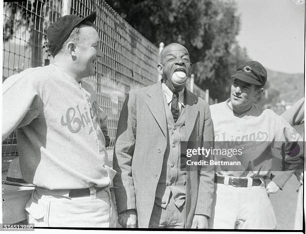 Oh, My What a Big Mouth Your Have! Says Gabby Hartnett, and Elwood English, right as they watch Sam Simpson, put a regulation baseball into his mouth...