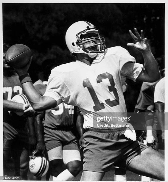 Miami Dolphin rookie quarterback Dan Marino who starred at the University of Pittsburgh winds up for a long pass during the Dolphin practice 8/4....