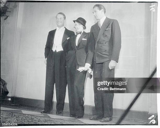 The tuxedo worn by Marlene Dietrich, famous screen star, vies in appearance with those worn by Maurice Chevalier and Gary Cooper, at the Biltmore...