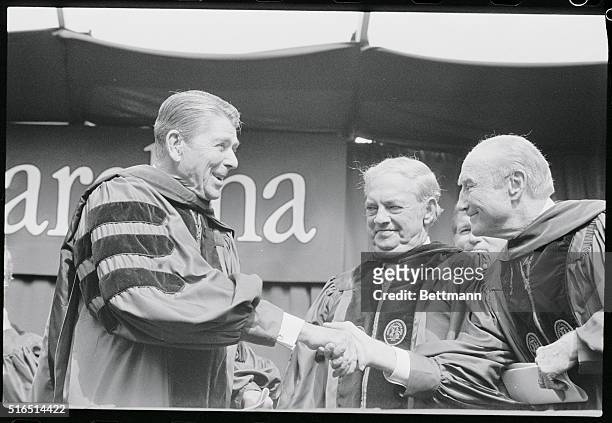 Columbia, S.C.: President Reagan is congratulated by Senator Strom Thurmond following his reception of an honorary doctor of laws degree from the...