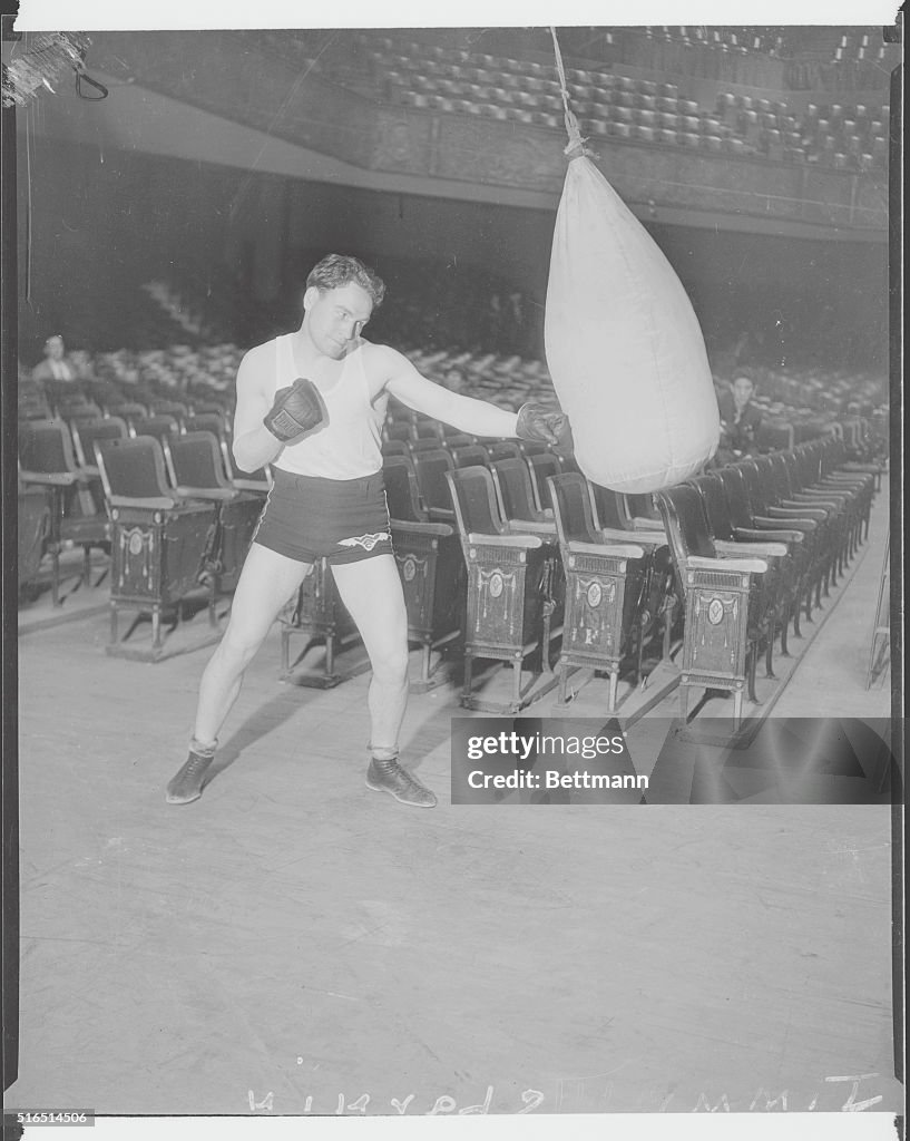 Boxer Jimmy McLarnin Practicing Punches in Stadium