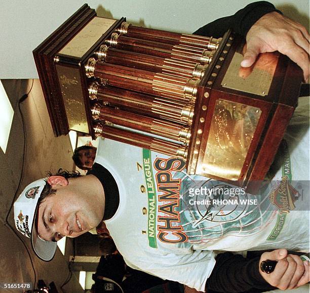 Florida Marlins pitcher Alex Fernandez holds the National League Championship Series trophy after his team's 7-4 victory over the Atlanta Braves 14...