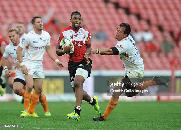 Howard Mnisi under pressure from Henco Venter of Cheetahs during the Super Rugby match between Emirates Lions and Toyota Cheetahs at Emirates Airline...