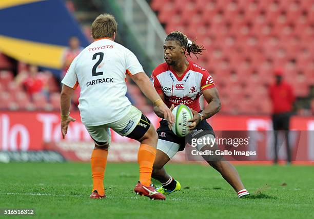 Howard Mnisi of Lions in action with Torsten van Jaarsveld of Cheetahs during the Super Rugby match between Emirates Lions and Toyota Cheetahs at...