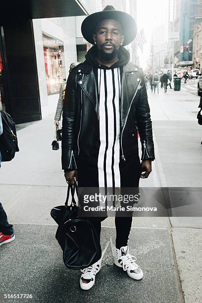 Fashion blogger Cambry Rouvens wearing leather H&M jacket, long Y3 hoodie, hat Forever 21 and Jeremy Scott Adidas seen on March 10, 2016 in New York...