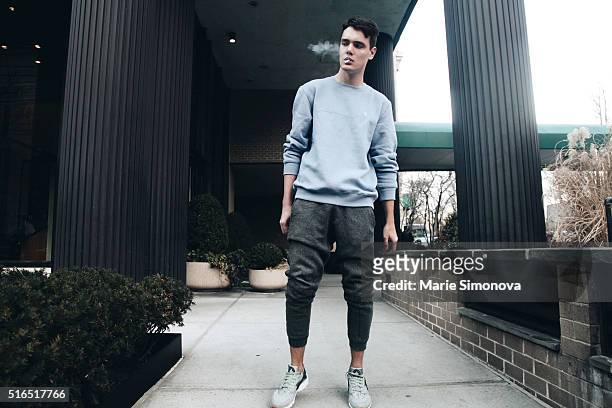 Nikita Kleshch wearing blue Izod sweater, grey H&M sweatpants and Nike Huarache shoes on March 10, 2016 in New York City.
