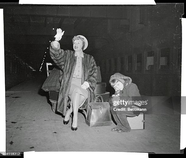 Eve Arden Arrival at Grand Central Station. Eve Arden poses off camera on her arrival here from Hollywood. Her 6-year-old daughter, Liza, is bored by...