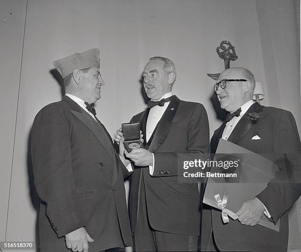Paul Ginsberg, the National Commander for Jewish War Veterans, presents the Jewish War Veteran's 1951 Gold Medal of Merit for "distinguished services...