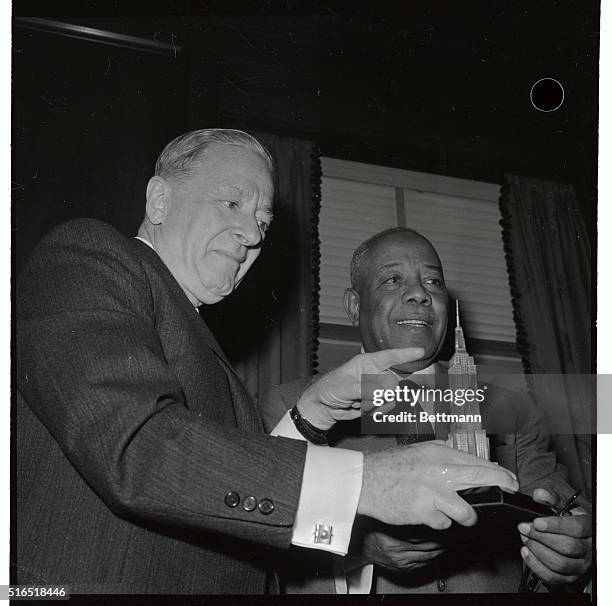 Left to right here is the owner of Empire State Building, Colonel Henry Crown, as he is presenting a model of the Empire State Building to the...