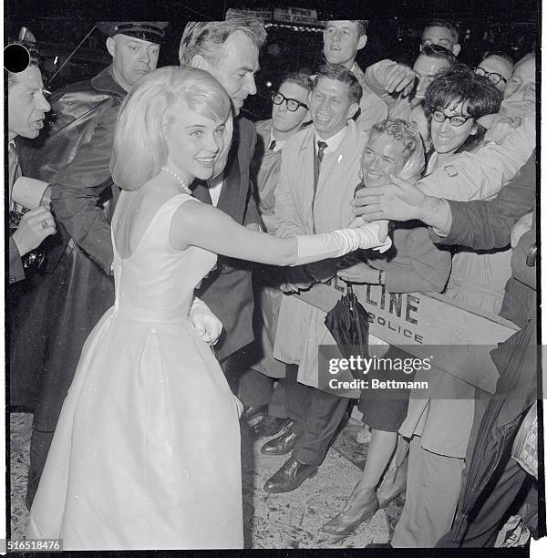 Loew's State Theatre: Sue Lyon and James Mason shaking hands with fans at the barricades here at the premiere of their film Lolita, which the young...