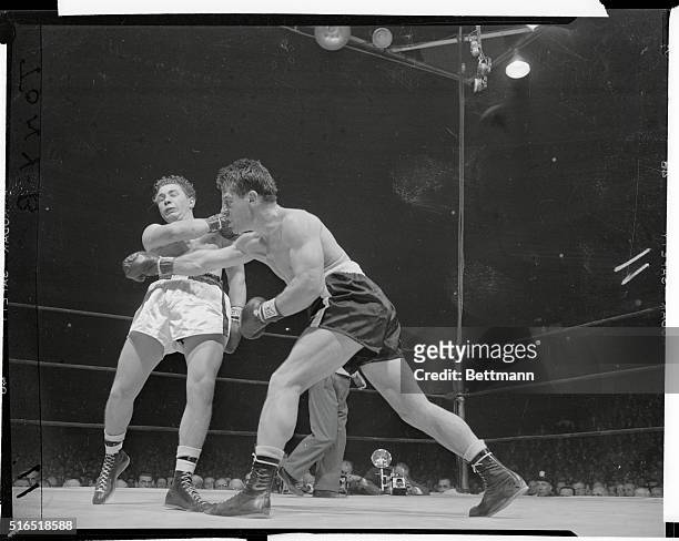 Dynamic laiden hand of Rocky Graziano has just bounced off the chin of Tony Janiro, in the fourth round of rough go at the Garden.