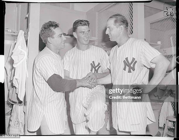 Mutual Admiration Society...Everybody smiles - and no wonder - as Tommy Byrne, Yankee hurler, is flanked by Yogi Berra and Tommy Heinrich after...