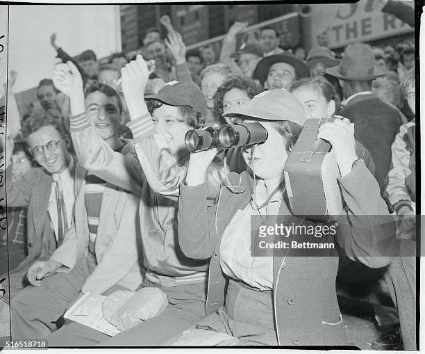 Marcia Fruchter, a Yankees fan, cheers enthusiastically at the Yankees-Red Sox game, September 23 while her friend, Ruth Holstein, trains her...