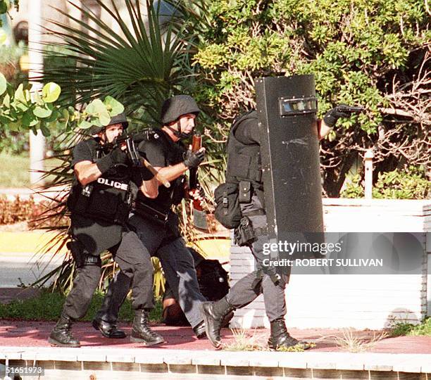 Miami Beach SWAT police move in on a houseboat 23 July after reports that it was occupied by a gunman in Miami Beach, FL. Police and FBI agents...