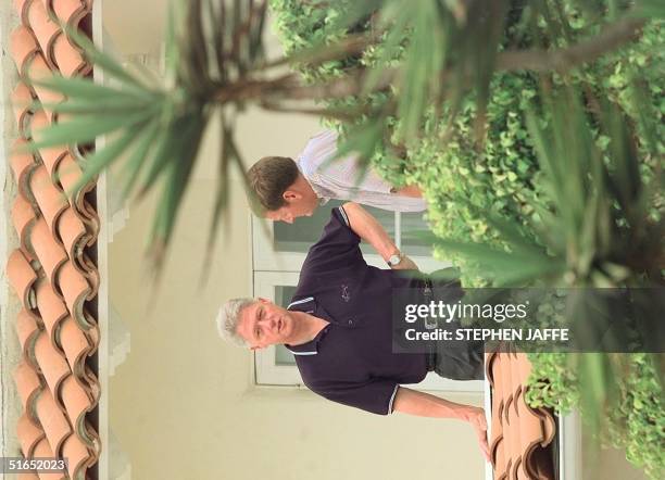 President Bill Clinton talks with grocery chain founder Ron Burkle of "Ralphs" grocery store at his Santa Monica beachfront home July 27 in Santa...