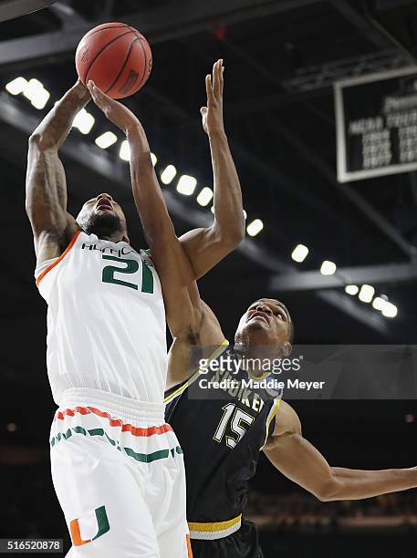 Kamari Murphy of the Miami Hurricanes battles for the rebound with Anton Grady of the Wichita State Shockers in the first half of their game during...