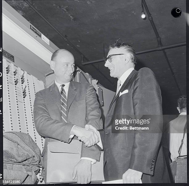 Voting Announcement. LTR: Edward I. Koch and Carmine DeSapio meet and shake hands at a board of election's warehouse during retabulating.