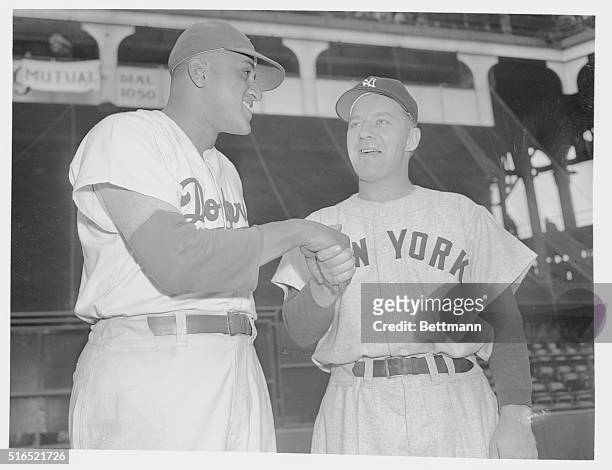 Hello and Goodbye. Don Newcombe , who lost 1-0 heartbreaker in series opener, shakes hands with rival starter, southpaw Ed Lopat of Bombers. Both...