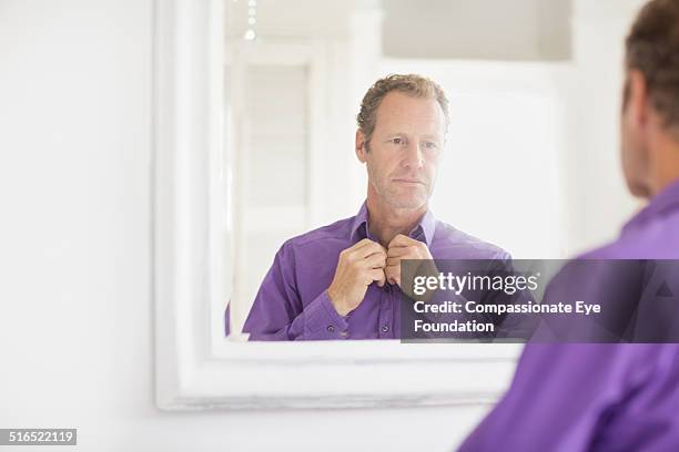 businessman examining himself in mirror - purple shirt fotografías e imágenes de stock