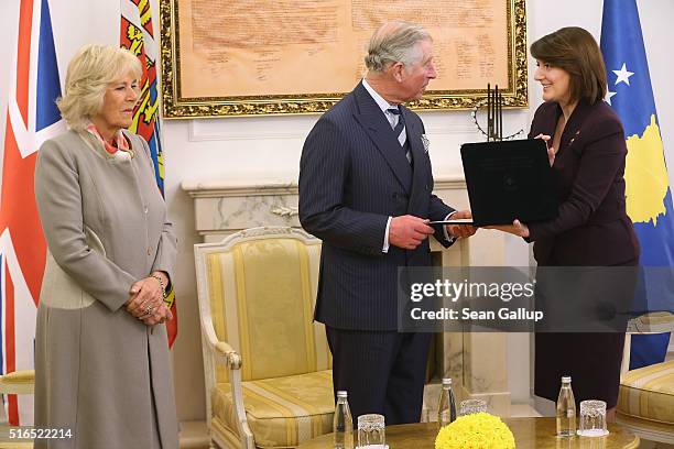 Prince Charles, Prince of Wales receives an award from Kosovo President Atifete Jahjaga as Camilla, Duchess of Cornwall, looks on at the Assembly of...