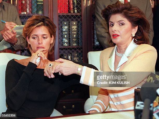 Model Kelly Fisher and her attorney Gloria Allred show off the large sapphire and diamond engagement ring given to her by former Egyptian fiancee...