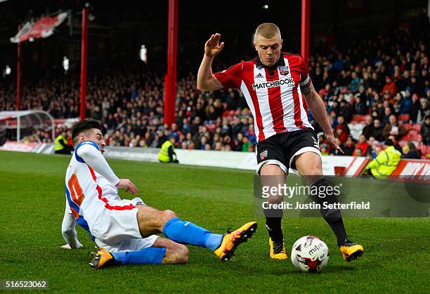 Jake Bidwell of Brentford FC is tackled by Ben Marshall of Blackburn Rovers during the Sky Bet Championship between Brentford and Blackburn Rovers on...