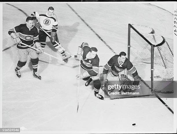 Boston, Massachusetts: Bruins center, McKenney, waits for rebound on Mackell's attempt in 1st period, as Montreal wing Olmstead goes after the puck....