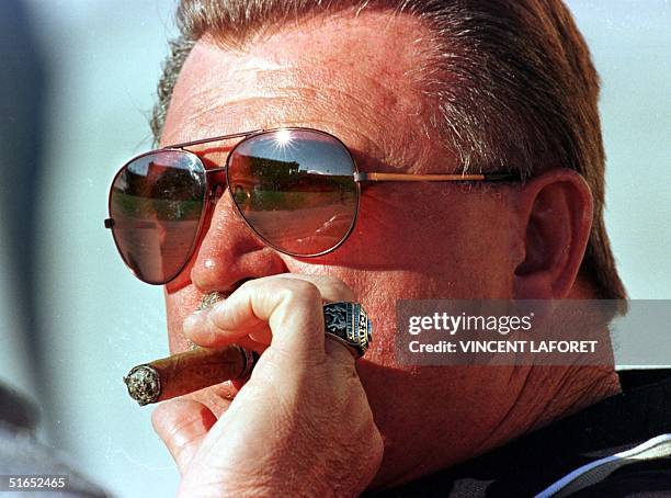 Soldier Field is reflected in the glasses of New Orleans Saints coach Mike Ditka as he smokes a cigar prior to the game against the Chicago Bears, 22...