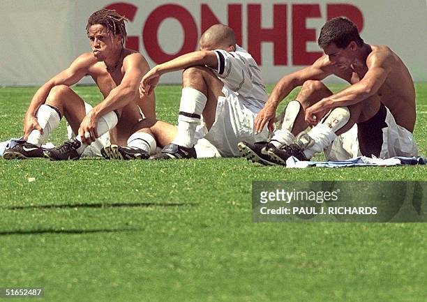 Los Angeles Galaxy midfielder Cobi Jones , teammate Martin Machon and an unidentified player sit on the grass after losing to Mexico's Cruz Azul in...