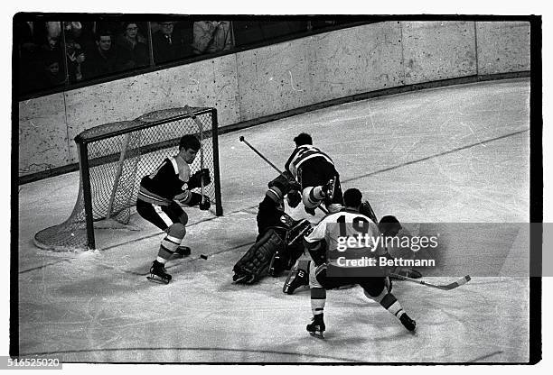 Bruins' Bobby Orr is about to pounce on a puck fired by Penguins' Mike Briere who dives over a fallen Boston Bruins' goalie Ed Johnston during first...