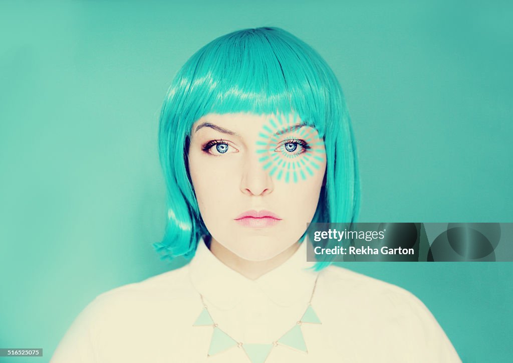 Young woman with blue hair and pulse from her eye