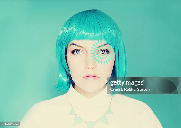 young woman with blue hair and pulse from her eye - bionic woman stock pictures, royalty-free photos & images