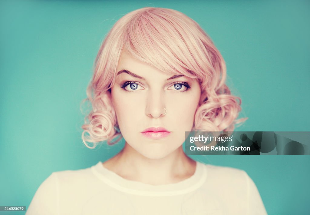 Young beautiful woman with pink curly hair