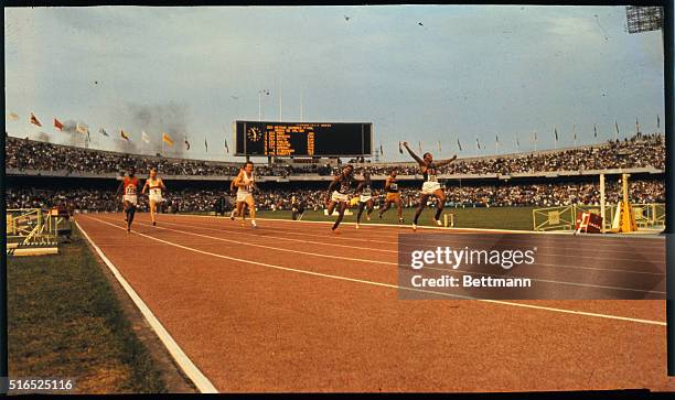 Mexico City, Mexico: Tom Smith of the U.S. Winning the final in the 200 meter dash. He ran the last five yards with his arms raised in the air in a...