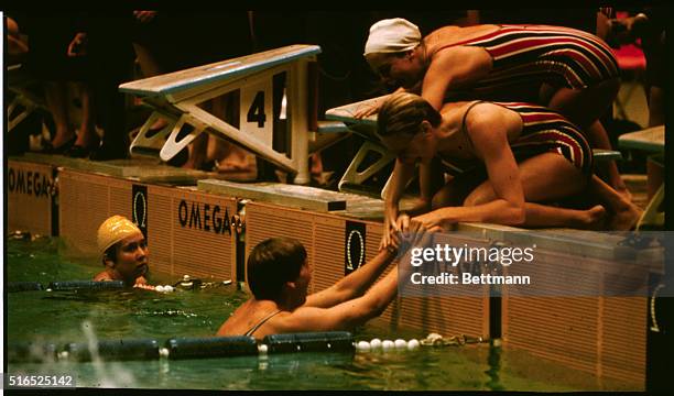 Mexico City: Members of the U.S. Women's 400-meter medley relay are joyous as final swimmer touches wall and is greeted by teammates. They won the...