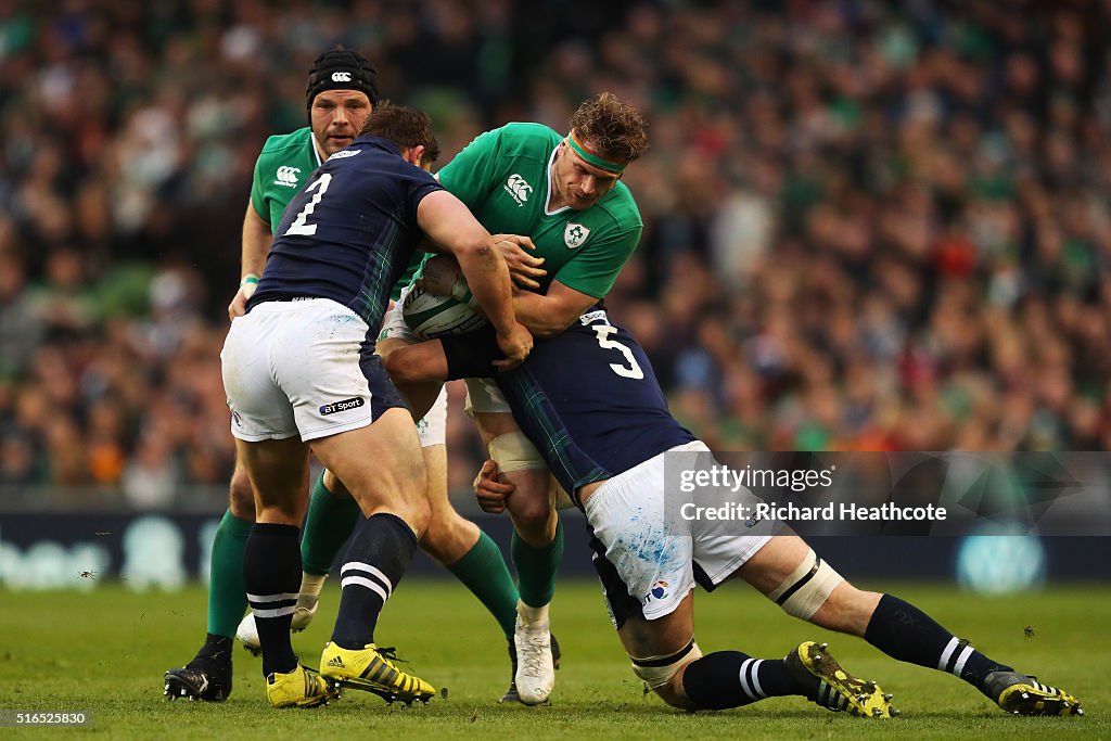 Jamie Heaslip of Ireland is tackled by Ross Ford and Tim Swinson of