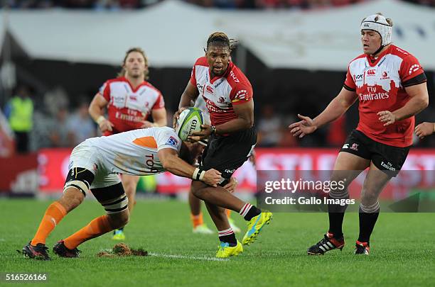 Howard Mnisi of Lions is tackled by Uzair Cassiem of Cheetahs during the Super Rugby match between Emirates Lions and Toyota Cheetahs at Emirates...