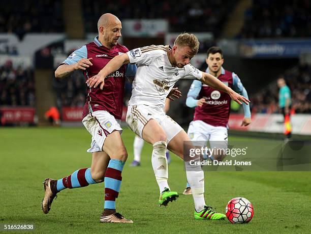 Stephen Kingsley of Swanseae City controls the ball under pressure of Alan Hutton of Aston Villa during the Barclays Premier League match between...