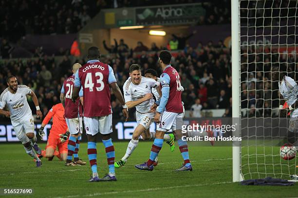 Federico Fernandez of Swansea City celebrates scoring his team's first goal with his team mates during the Barclays Premier League match between...