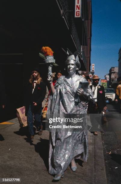 New Orleans, LA: Various scenes of floats and costumed stroller at the Mardi Gras parade include a silver painted Statue of Liberty, Joe Anne Jennell...