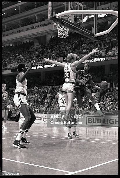 Supersonics' Gerald Henderson , a former Celtics' player goes up for a layup around old teammate Larry Bird of Boston during 1st quarter action in...